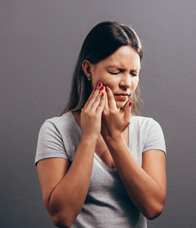 Woman in pain, touching the side of her face
