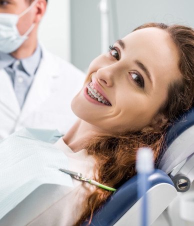 Young woman with braces in dental treatment chair