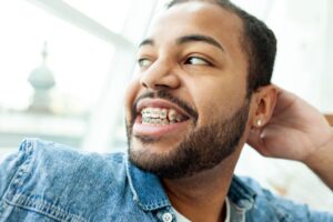 Portrait of handsome, smiling man with braces